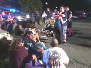 Victims are tended to in the parking lot of an Aurora theater, where a mass shooting occurred during the premiere of "The Dark Night Rises," July 20, 2012.