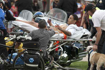 A man is taken away on a stretcher after shots were fired at Denver's Civic Center Park 4/20 rally on April 20, 2013 (Photo courtesy: Daniel Harlan)