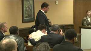 Trent Mays (seated, middle) holds a tissue to his face after learning of the guilty verdict.