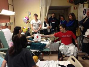 Jeff Bauman delivers a gift to Sydney Corcoran at Boston Medical Center. (Photo Credit: Celeste & Sydney Corcoran Support Page)