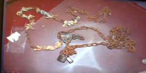 (A photo shows some of many chains and padlocks used to restrain the captives inside Castro's home.)