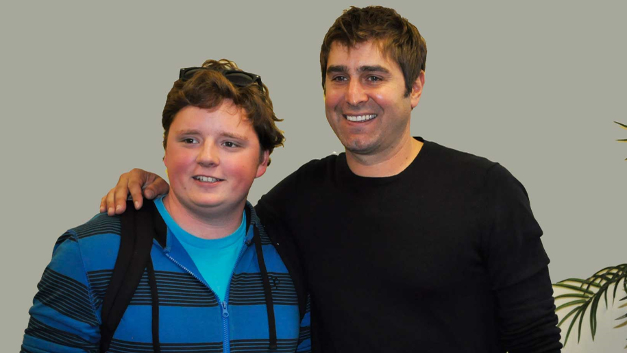 Trevor Long, DCCC student working toward an Associate in Science degree, poses with MythBusters star Tory Belleci. 