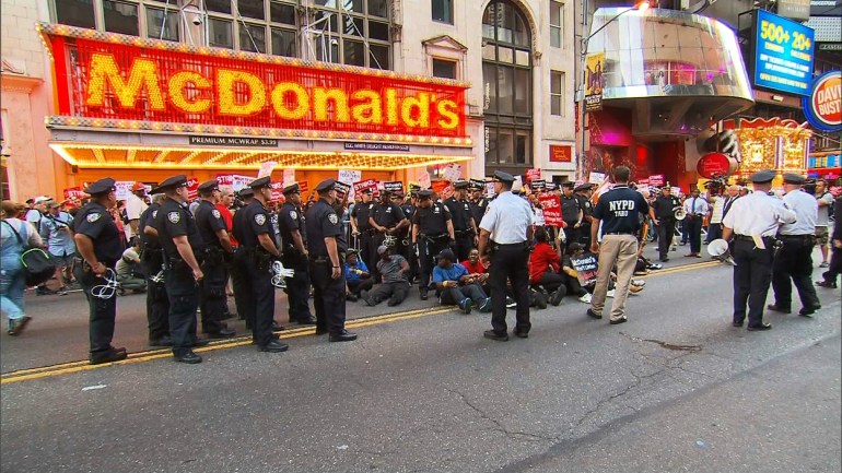 Fast-food workers blocked a street in front of a Manhattan McDonald's restaurant Thursday morning, September 4, 2014. Some of the protesters were arrested by NYPD. (CNN)