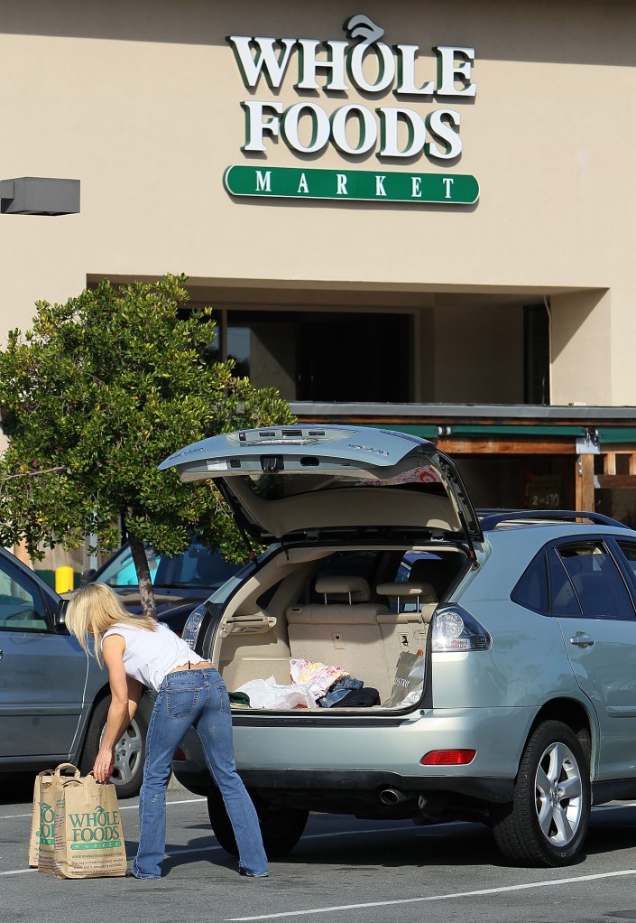 A customer loads bags of groceries into her car at a Whole Foods store February 17, 2010 in San Rafael, California. (Photo by Justin Sullivan/Getty Images)