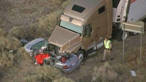 A California Highway Patrol officer is seen at a fatal crash site in Lancaster on Monday, June 30, 2014. (Credit: KTLA)