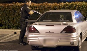 An officer approached Stretton, who was inside the vehicle, outside the Upland Police Station on June 27, 2014. (Credit: Eric Rosenwald)