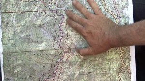 A search-and-rescue official points shows the area being searched for Mike Herdman on a topographic map on June 17, 2014. (Credit: KTLA)