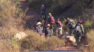 Searchers head up the trail to look for missing firefighter Mike Herdman in Los Padres National Forest on June 18, 2014. (Credit: KTLA)