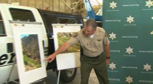 Sheriff Geoff Dean points to photos of the location where Mike Herdman's body was found June 27, 2014. (Credit: KTLA)