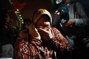  A family member cries as she receives the news of the ill fated flight MH17 on the phone on July 18, 2014 in Kuala Lumpur, Malaysia. Air Malaysia flight MH17 travelling from Amsterdam to Kuala Lumpur has crashed on the Ukraine/Russia border near the town of Shaktersk. The Boeing 777 was carrying 280 passengers and 15 crew. (Credit: Rahman Roslan/Getty Images)