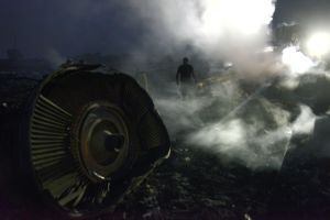 A man walks on July 17, 2014, among the wreckage of the Malaysian airliner after it crashed near the town of Shaktarsk in rebel-held east Ukraine. The plane was shot down over Ukraine by a surface-to-air missile Thursday but it was unclear who fired the weapon, U.S. officials said. Intelligence analysts are reviewing data to determine whether the weapon was launched by pro-Moscow separatists in Ukraine, Russian troops across the border or Ukrainian government forces, said two U.S. officials, who spoke on condition of anonymity. AFP PHOTO/ ALEXANDER KHUDOTEPLY (Photo credit should read Alexander KHUDOTEPLY/AFP/Getty Images)