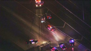 Dozens of police and Highway Patrol officers were conducting a search of freeway. (Credit: KTLA)