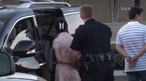 A Fullerton couple was handcuffed in the Brea Mall parking lot after their daughter was found alone inside their hot car. (Credit: First In)