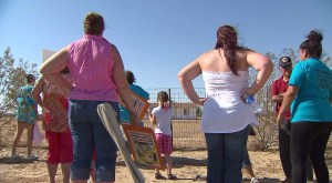 Protesters gathered July 9, 2014, in front of the home where serial rapist Christopher Hubbart was released. (Credit: KTLA)