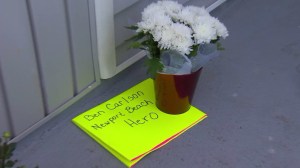 Flowers and cards were left outside a City of Newport Beach office after lifeguard Ben Carlson died while on duty on July 6, 2014. (Credit: KTLA)