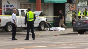 Investigators work at the scene of a hit-and-run collision that killed one man and left two others in critical condition on July 28, 2014. (Credit: KTLA)