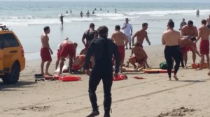 A swimmer was being treated on Venice Beach after being struck by lightning on July 27, 2014. (Credit: Peter Faust)