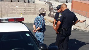 Police handcuffed a man during protests in Murrieta on July 4, 2014. It was not immediately clear if he was arrested. (Credit: KTLA)