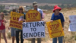 About 100 people protested the arrival of 140 undocumented immigrants in Murrieta on July 1, 2014. (Credit: KTLA)