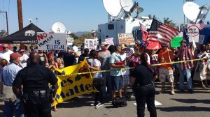 Dozens of supporters and protesters were out in Murrieta on July 4, 2014, as another group of 140 undocumented immigrants was expected to arrive at the U.S. Border Patrol Facility in the Riverside County city. (Credit: Steve Kuzj/KTLA)