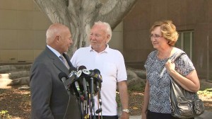 Stow family attorney Tom Girardi talks to media alongside David and Ann Stow after the verdict was delivered on July 9, 2014. (Credit: KTLA)