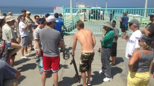 Beachgoers waited to find out when they could swim at Manhattan Beach after the local area was closed down on  July 5, 2014, following a shark attack. (Credit: KTLA)