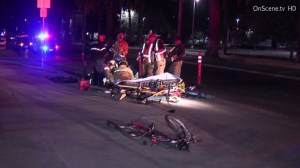 Paramedics attend to a bicyclist who was struck by a suspected DUI driver in Pomona on Saturday, July 19, 2014. The victim later died of his injuries, police said. (Credit: OnScene.tv HD)