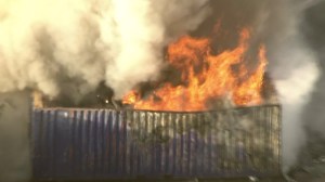 Fire crews were battling a blaze that broke out near a recycling facility in Pomona on July 9, 2014. (Credit: KTLA)