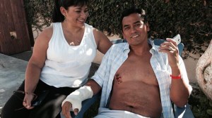 Steve Robles recovered at his Lomita home with his wife, Glenda Robles (left), after he was attacked by a shark on July 5, 2014. (Credit: KTLA)