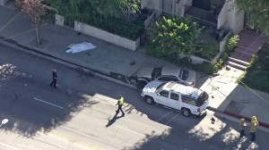 A crash in the San Fernando Valley involving a cyclist and two vehicles left one person dead on July 17, 2014. (Credit: KTLA)