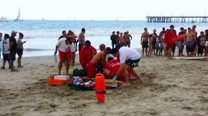 Medics aided a victim of a lightning strike that killed one person and led to the hospitalization of seven others on July 26, 2014. (Credit: KTLA)