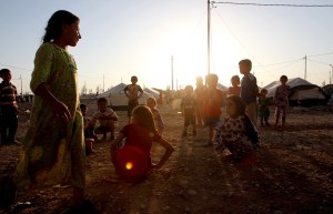 Displaced Iraqi children, who fled their home a few weeks ago due to attacks by Islamic State jihadists in the northern city of Mosul, play at the Bahrka camp where they found shelter, west of Arbil, in the autonomous Kurdistan region of Iraq, on Wednesday, Aug. 27, 2014. (Credit: Ali Al-Saadi/AFP/Getty Images)