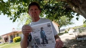 Ben Devitt holds a photo of his wife, Pamela Maria Devitt, who was killed by a pack of pit bulls on May 9, 2013, in Littlerock. (Credit: Irfan Khan / Los Angeles Times)