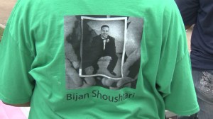 A photo of Bijan Shoushtari is seen on a T-short worn by an attendee at a prayer vigil in Leimert Park on Sunday, Aug. 3, 2014. (Credit: KTLA)