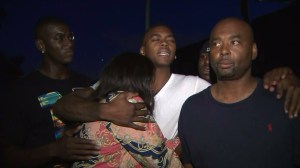 Tritobia Ford is comforted by family members on Aug. 12, 2014, the night after her son was fatally shot by police. (Credit: KTLA)