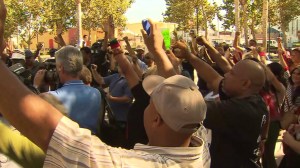 At a peaceful protest in Leimert Plaza Park, hundreds raised their hands during a moment of silence for Mike Brown on Aug. 14, 2014. (Credit: KTLA)