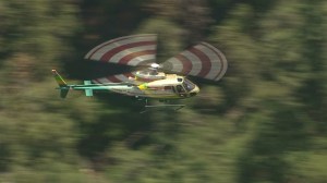 A Los Angeles County Sheriff's Department helicopter flies over a search area for possible missing people on Mount Baldy on Aug. 4, 2014. (Credit: KTLA)