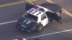 A pursuit ended at the intersection of 37th and Hill streets in South Los Angeles before one of two gunman was shot and killed by police on Monday, Aug. 18, 2014, authorities said. A second shooter was taken into custody. (Credit: KTLA)