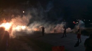 Demonstrators in Ferguson, Mo., scatter Monday night after police fired tear gas. (Credit: L.A. Times)