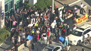 Protesters faced off with officers in front of LAPD's Newton Division in South Los Angeles on Aug. 15, 2014, over the killing of Ezell Ford. (Credit: KTLA)