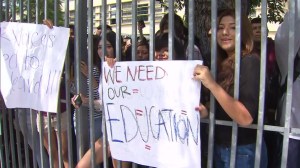 Students held up signs in a protest focused on scheduling problems at Jefferson High on Aug. 25, 2014. (Credit: KTLA)