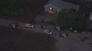 Police were investigating an officer-involved shooting that left one alleged gunman dead and an officer in grave condition on Aug. 22, 2014. (Credit: KTLA)