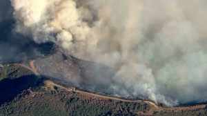 Firefighters worked along ridgelines to contain the fire in early evening on Sept. 12, 2014. (Credit: KTLA)