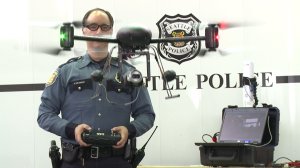 A still from a video showed Seattle police officers using a drone. The Seattle department gave its drones to LAPD in May 2014 amid controversy. (Credit: KCPQ)