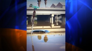 A car was almost completely submerged in water under near the 91 Freeway at the intersection of 14th Street and Vine Street in Riverside County after a flash flood warning on Sept. 7, 2014. (Credit: Mark Mester/ KTLA) 