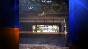 Two cars were almost completely submerged in water under the 91 Freeway at 14th Street in Riverside County during a flash flood on Sept. 7, 2014. (Credit: Mark Mester/KTLA)