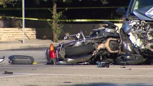 Officer Jordan Corder's motorcycle remained in the intersection after a collision that killed him in Covina on Sept. 30, 2014. (Credit: KTLA)