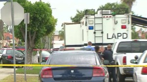 Investigators remained on the scene hours after a man involved in a domestic violence call was shot and killed by LAPD officers. (Credit: KTLA)