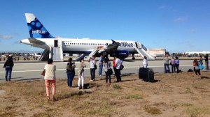 A plane was forced to return to the airport due to engine trouble. Passengers evacuated the plane via emergency slides. (Credit: Dave Boyle/via Twitter)