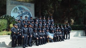 In this photo provided by LAPD Officer Erick Alcaraz's family, the 24-year-old (sitting on the bottom row, right) is seen with other police academy graduates. He died in an off-duty motorcycle crash on Sept. 6, 2014. 